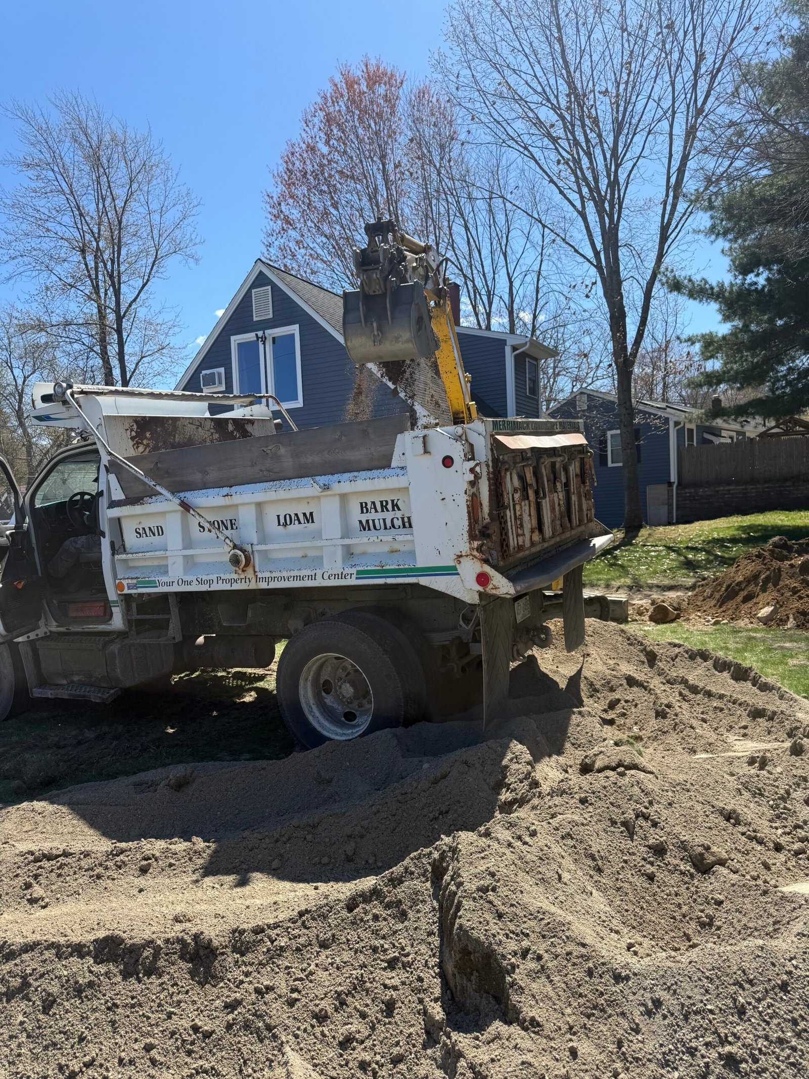 Dump truck staged beside an active excavation area