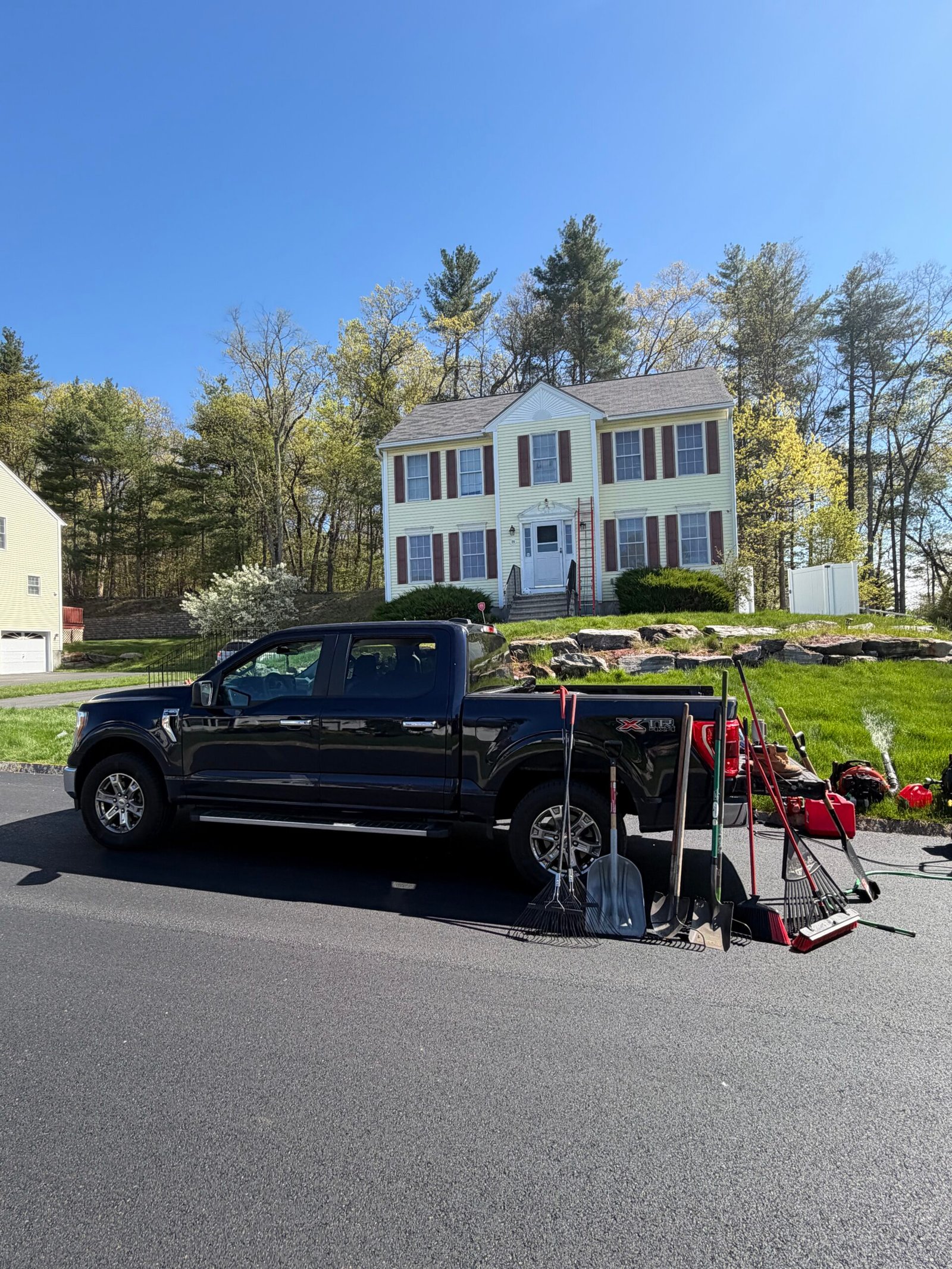 Landscaping truck and equipment set up outside a home
